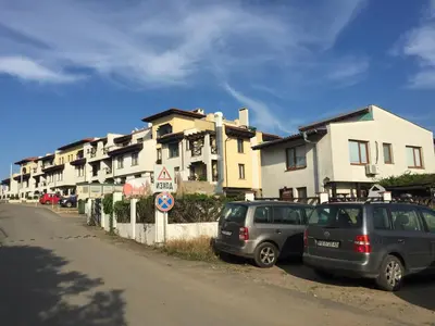two cars parked on the side of a street with buildings at Apartment on the sea at St Nikolas Complex-Veronika in Chernomorets
