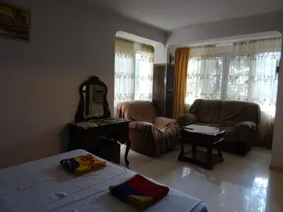 a living room with a bed and a mirror at Apartment Kafedral in Varna City
