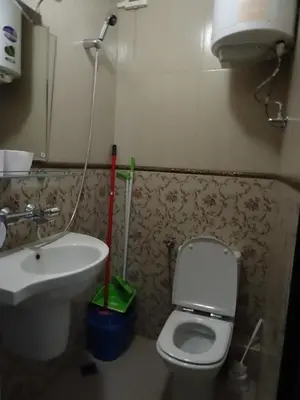 a bathroom with a white toilet and a sink at Apartment Kafedral in Varna City