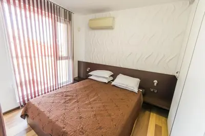 a bedroom with a bed with two pillows on it at City Apartments La Casa in Varna City