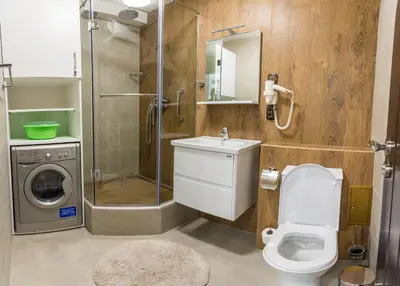 a bathroom with a toilet and a shower and a sink at City Apartments La Casa in Varna City