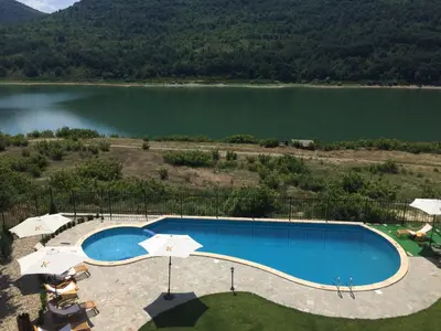 an overhead view of a swimming pool next to a lake at Eco House Kitana in Tschenge