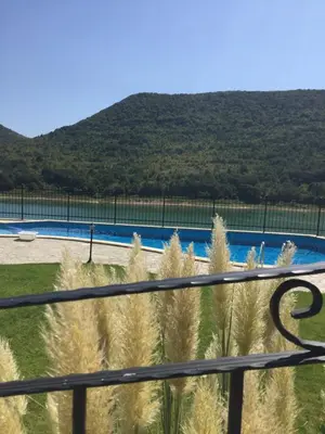 a view of a swimming pool from a fence at Eco House Kitana in Tschenge