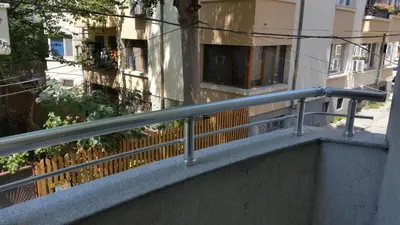 a railing on a balcony in front of a building at 4U Apartment in Burgas City
