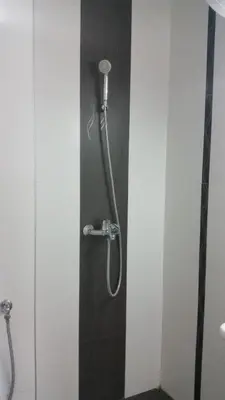 a shower in a bathroom with a shower head at 4U Apartment in Burgas City