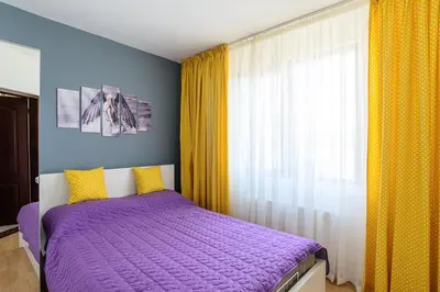 a bedroom with a purple bed and a window at Villa Maja in Varna City