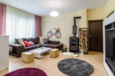 a living room with a couch and a tv at Galata Residence in Varna City
