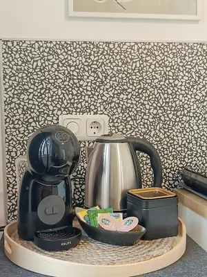a kitchen counter with a coffee maker and a tea kettle at Apartment Balabanov in Varna City
