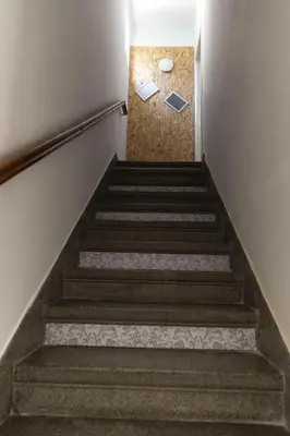 a set of stairs in a building with a notebook on the floor at Apartment Balabanov in Varna City