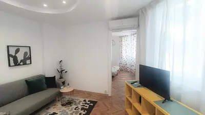 a living room with a couch and a flat screen tv at Apartment Balabanov in Varna City