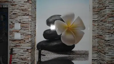 a painting of a pile of rocks with a flower on it at Sadala Guest House in Nesebar