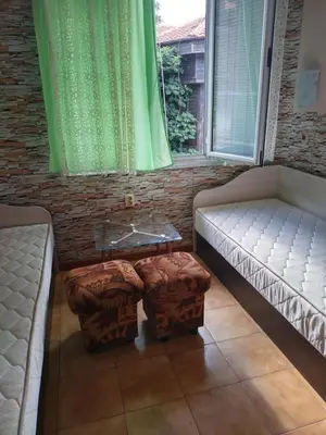 a room with two beds and two ottomans at Sadala Guest House in Nesebar