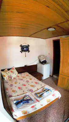 a bedroom with a bed with a wooden ceiling at Atanasovi House in Shkorpilovtsi