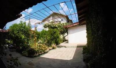 a view of a garden with plants and a building at Atanasovi House in Shkorpilovtsi