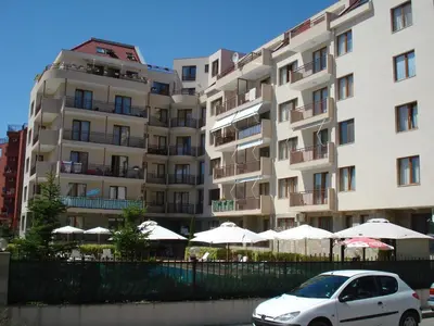 a white car parked in front of a building at Summer Breeze Apartments in Sunny Beach