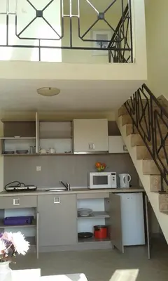 a kitchen with a sink and a staircase at Summer Breeze Apartments in Sunny Beach