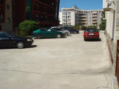a group of cars parked in a parking lot at Summer Breeze Apartments in Sunny Beach