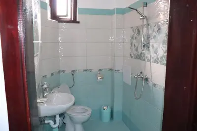 a bathroom with a sink and a toilet and a shower at Guest House Zhelevi in Sozopol