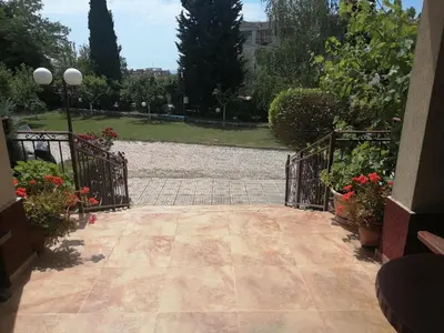 an entrance to a garden with a gate and flowers at St. George Guest House in Sveti Vlas