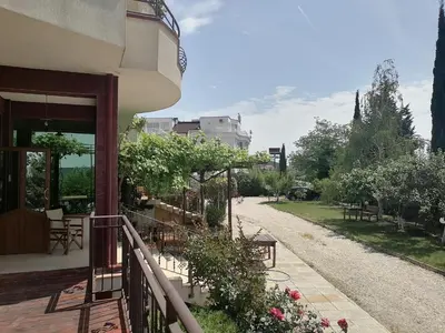 a balcony of a building with flowers and a pathway at St. George Guest House in Sveti Vlas