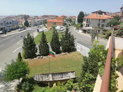 a view of a city with a flag on a field at St. George Guest House in Sveti Vlas