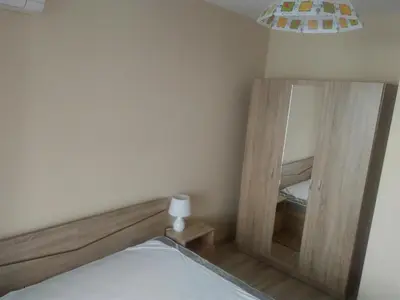 a bedroom with a bed and two mirrors at Sea'n'Pool Apartments in Hotel in Sozopol