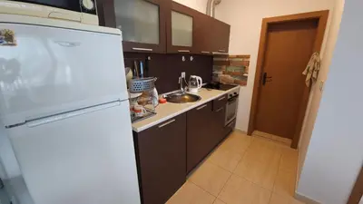 a kitchen with a white refrigerator and a sink at Complex Top Apartment in Sveti Vlas