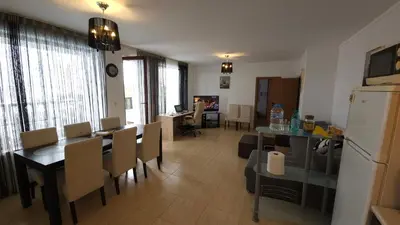 a kitchen and dining room with a table and chairs at Complex Top Apartment in Sveti Vlas