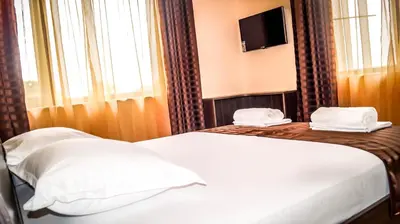a hotel room with a bed and a television at Guest House Meridi in Priseltsi