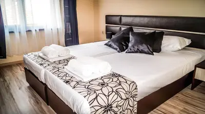 a bed with two towels on top of it at Guest House Meridi in Priseltsi