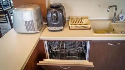 an open dishwasher in a kitchen next to a toaster at Guest House Meridi in Priseltsi