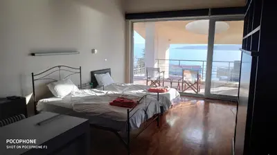 a bedroom with a bed and a balcony at Budzhaka Villa in Sozopol
