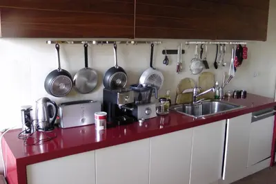 a kitchen counter with a sink and pots and pans at Budzhaka Villa in Sozopol