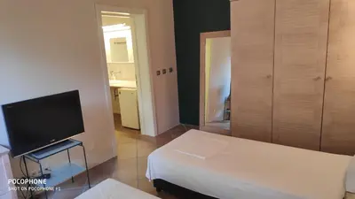 a small room with a bed and a television at Budzhaka Villa in Sozopol