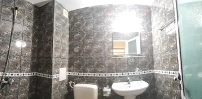a bathroom with a sink and a toilet and a mirror at Kovachevi House in Primorsko