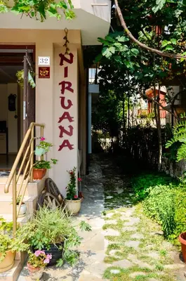 a building with a sign on the side of it at Nirvana Guest House in Nesebar