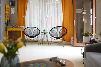 a living room with two chairs and a table at Nirvana Guest House in Nesebar