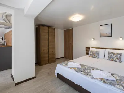 a bedroom with a large bed in a room at Home Gramatikovi in Pomorie