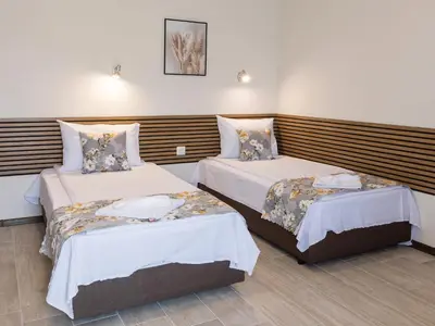a hotel room with two beds in a room at Home Gramatikovi in Pomorie