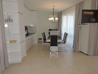 a kitchen and dining room with a table and chairs at Green Paradise Deluxe Apartments in Primorsko