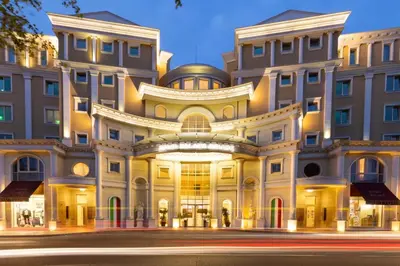 a large building on a street at night at Rome Palace Deluxe - All Inclusive Premium in Sunny Beach