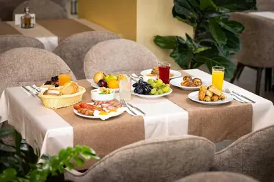 a table with plates of food and fruit on it at Rome Palace Deluxe - All Inclusive Premium in Sunny Beach
