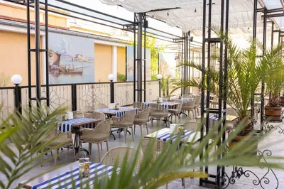 a restaurant with blue and white tables and chairs at Rome Palace Deluxe - All Inclusive Premium in Sunny Beach