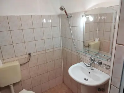 a bathroom with a sink and a mirror at Zlatevi Guest House in Obzor