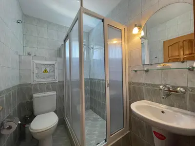a bathroom with a shower and a toilet and a sink at Apartments Panorama Ravda in Ravda