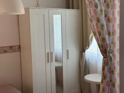 a white cabinet in a bathroom with a toilet at Apartments Panorama Ravda in Ravda