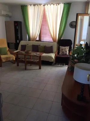 a living room with a couch and a table at Siana 1 Apartment in Sveti Vlas