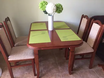 a wooden table with a vase of flowers on it at Siana 1 Apartment in Sveti Vlas