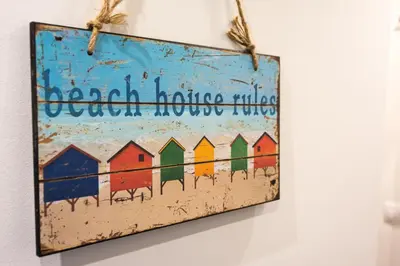 a painting of colorful beach huts hanging on a wall at Guest Rooms Old Captain in Burgas City
