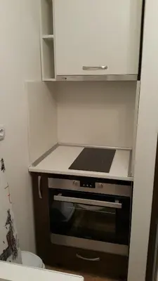a kitchen with a stove top oven in a cabinet at Guest Rooms Old Captain in Burgas City